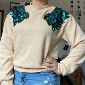 Shein beige sweater with green and blue sequin winged shoulders